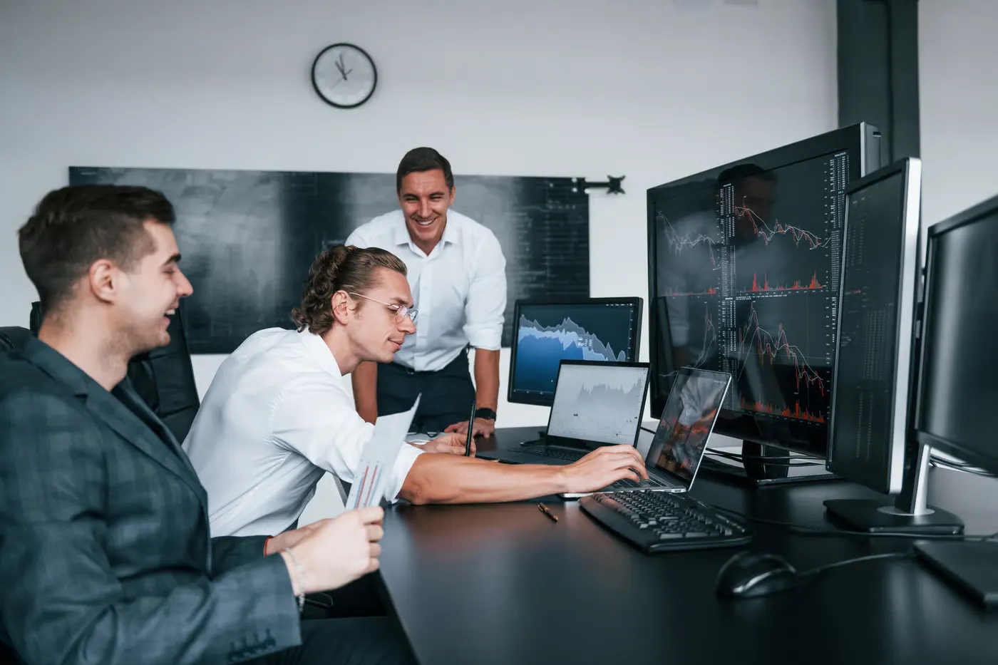 Business team reviewing information across multiple displays